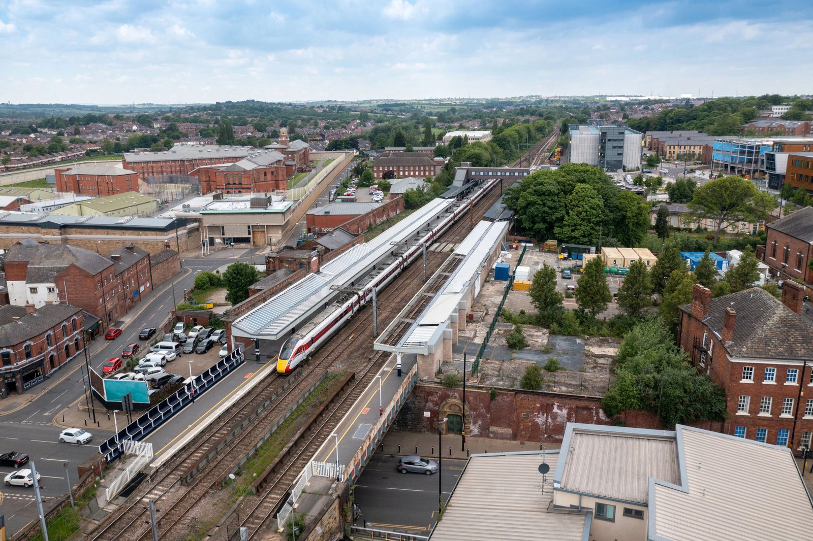 Aerial drone photo of the town centre of Wakefield in West Yorkshire in the UK showing a train in the main train station in the town centre